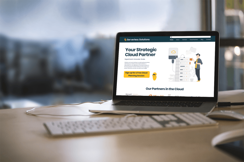 A laptop is sitting on a desk displaying the new Serverless Solutions website.